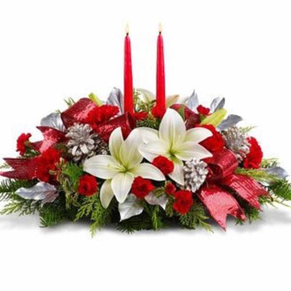 Red and white floral centerpiece with two red candles