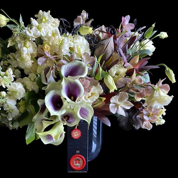 Bouquet of white and lavender flowers in a dark vase