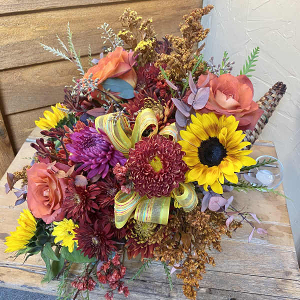 Bouquet of sunflowers, roses, and chrysanthemums with a ribbon accent
