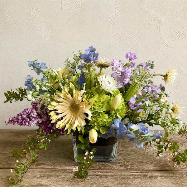 Mixed pastel bouquet in a square glass vase