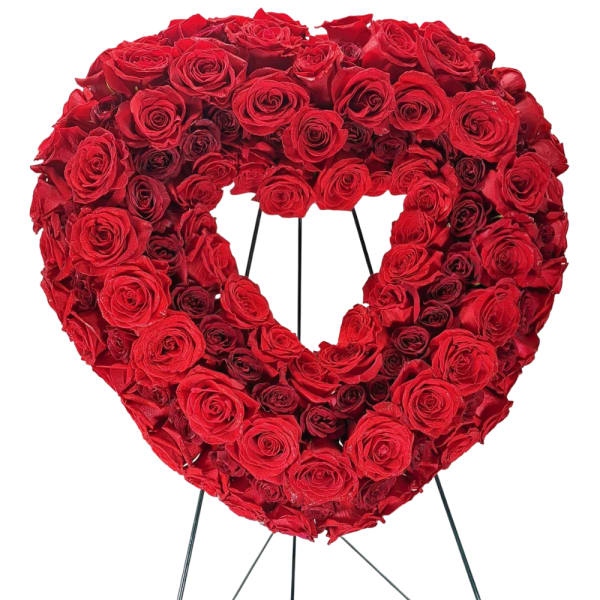 Heart-shaped wreath of red roses on a metal stand