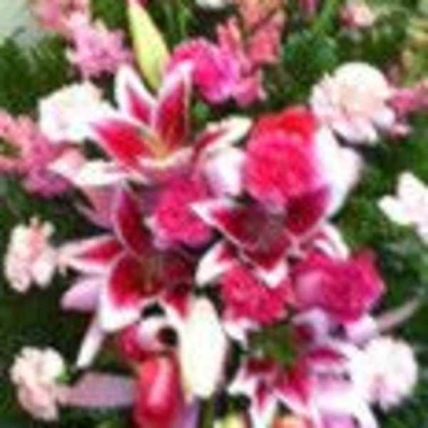 Pink and white floral spray with lilies and carnations