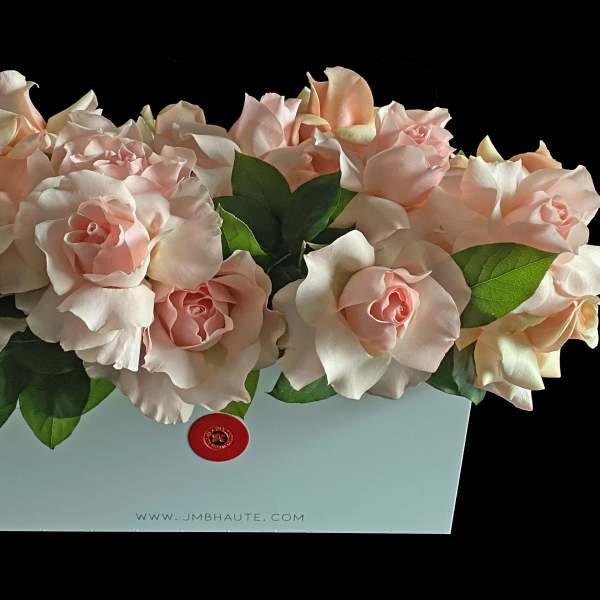 Arrangement of pale pink roses in a light blue box