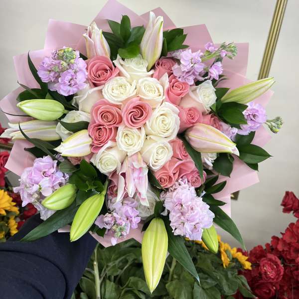 Pink and white rose bouquet with lilies and lavender flowers