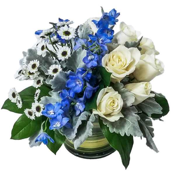 Blue and white flowers arranged in a glass vase