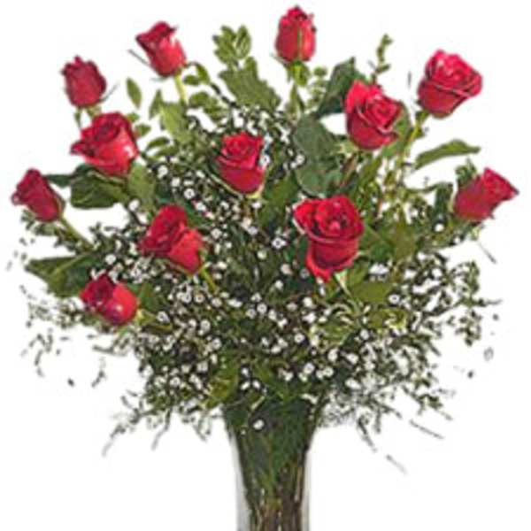 Red roses arranged in a clear glass vase