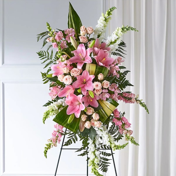 Tall pink and white floral standing spray on an easel