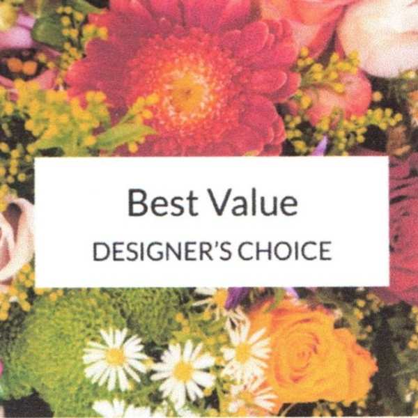 Designer’s choice floral arrangement with bright mixed blooms and a label card