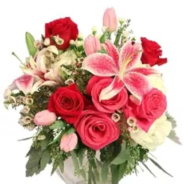 Bouquet of red roses and pink lilies in a glass vase