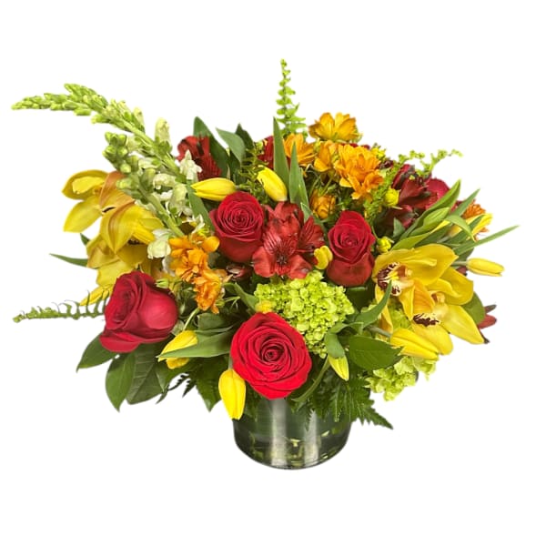Mixed bouquet of red roses and yellow flowers in a glass vase