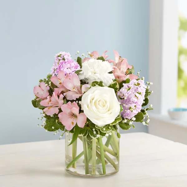Pink and white bouquet in a clear glass vase