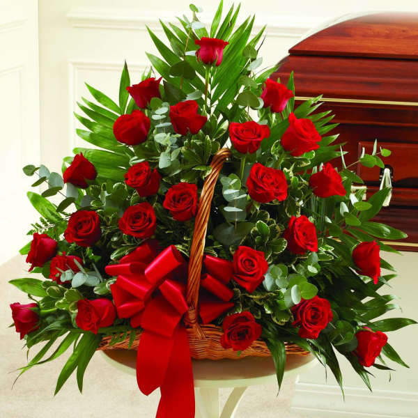 Basket arrangement of red roses with a red ribbon