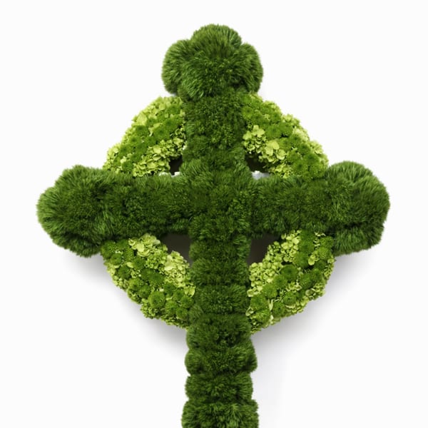 Green floral cross made of mossy blooms and hydrangeas