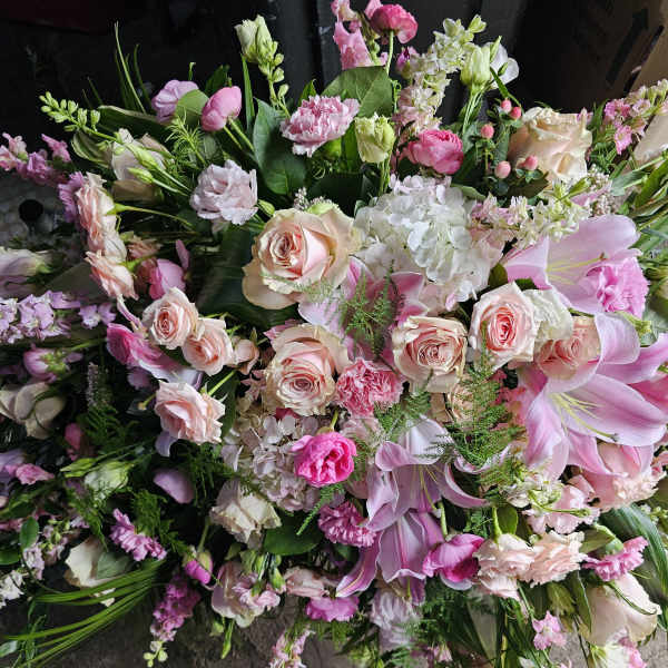 Large pink and white mixed bouquet with roses, lilies, and hydrangeas
