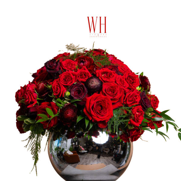 Large red rose arrangement in a mirrored round vase