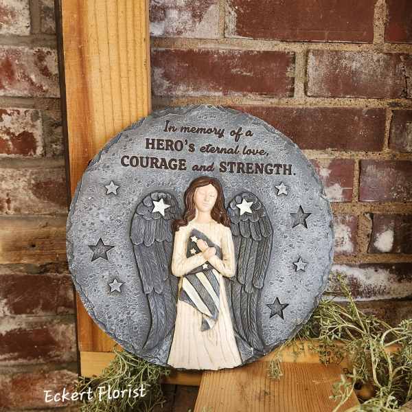 Round memorial plaque with an angel and the words "In memory of a HERO's eternal love, COURAGE and STRENGTH."