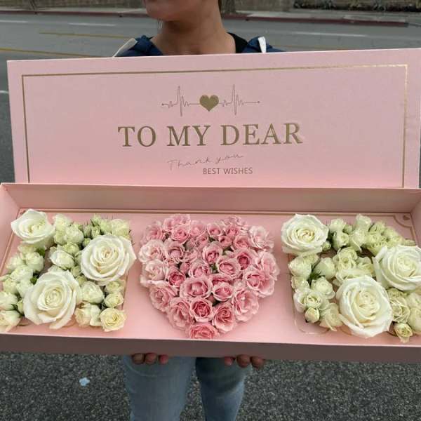 Pink gift box with roses and a heart-shaped floral arrangement