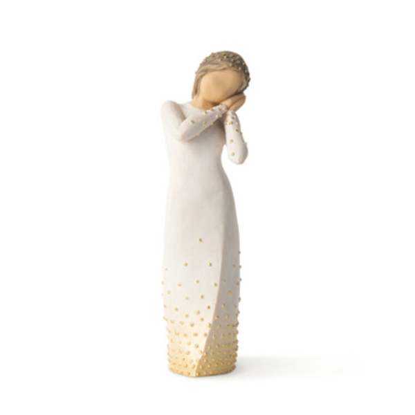 Decorative figurine of a woman in a long white dress with gold accents