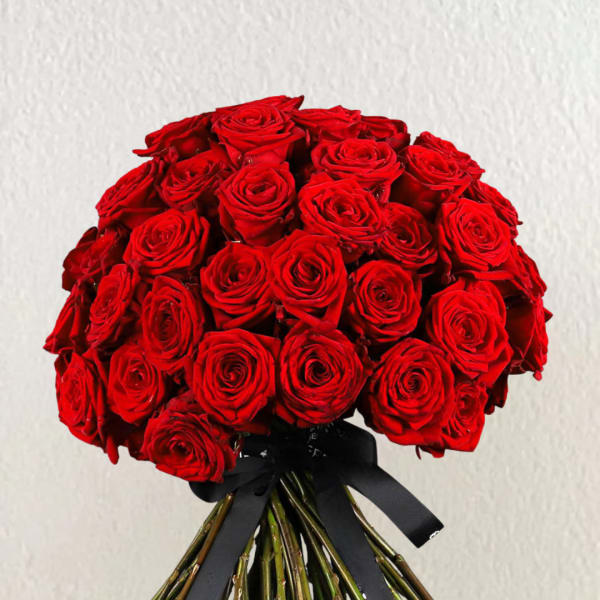Bouquet of red roses tied with a black ribbon