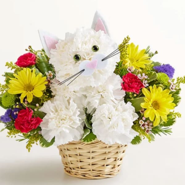 Cat-shaped flower arrangement in a wicker basket with white, yellow, red, and purple blooms