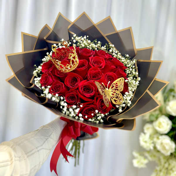 Bouquet of red roses with baby's breath and decorative butterfly accents