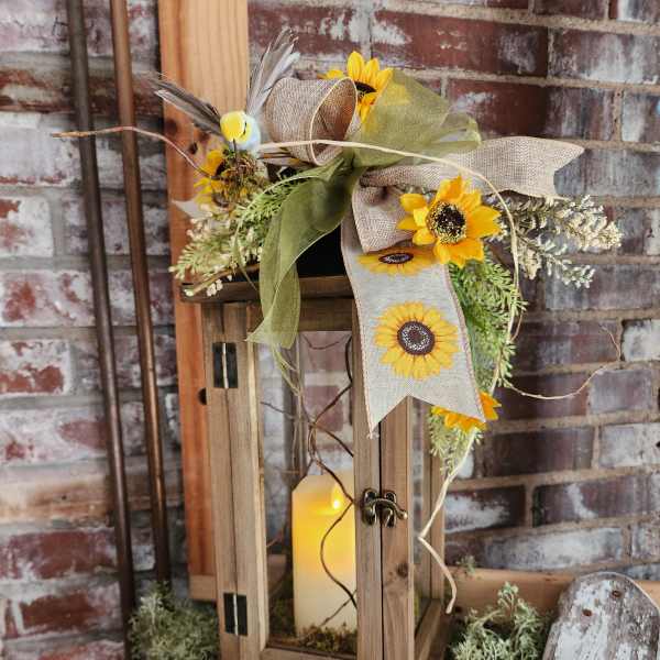 Sunflower arrangement on a wooden lantern with a candle inside