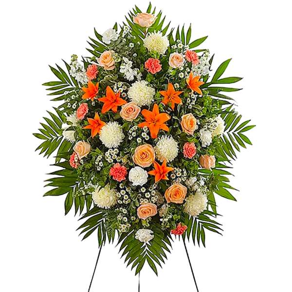 Standing floral spray with peach roses, orange lilies, and white blooms