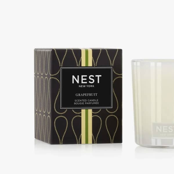 Scented candle in a glass tumbler beside its box