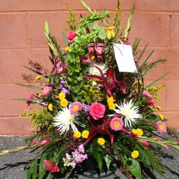 Large mixed floral arrangement with pink, yellow, and white blooms