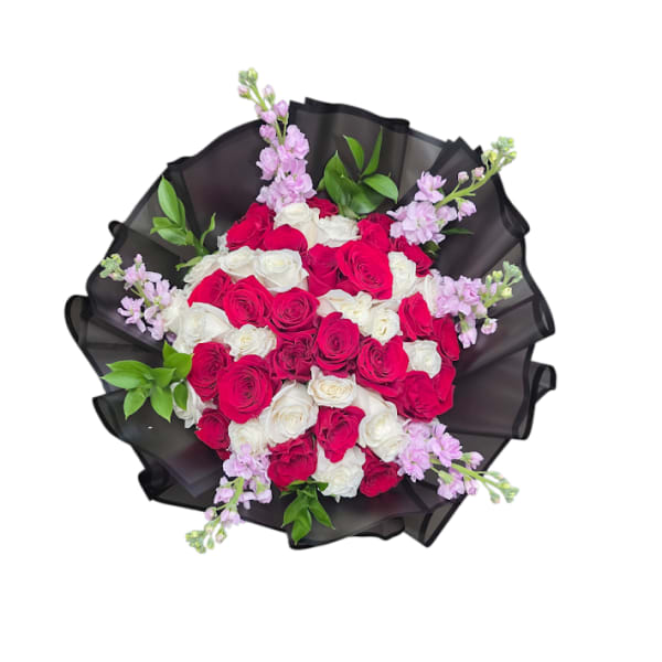 Bouquet of red and white roses with light purple accents wrapped in black paper