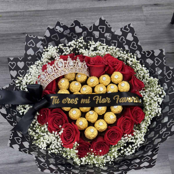 Heart-shaped bouquet of red roses and gold chocolates with a tiara