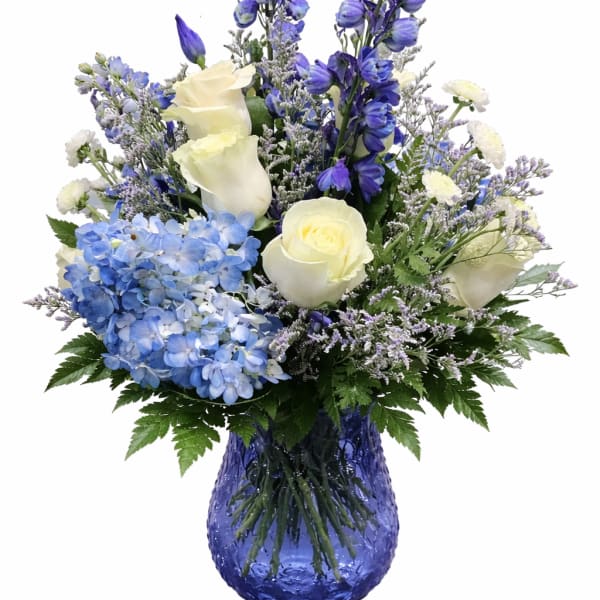 Blue and white floral arrangement in a cobalt glass vase