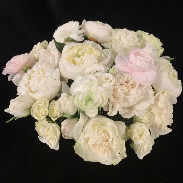 Bouquet of white and blush roses and peonies on a black background