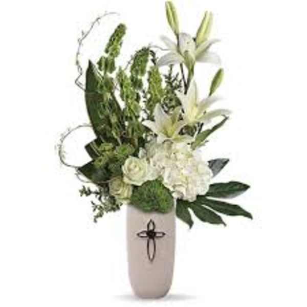 White lilies and roses in a tall beige vase