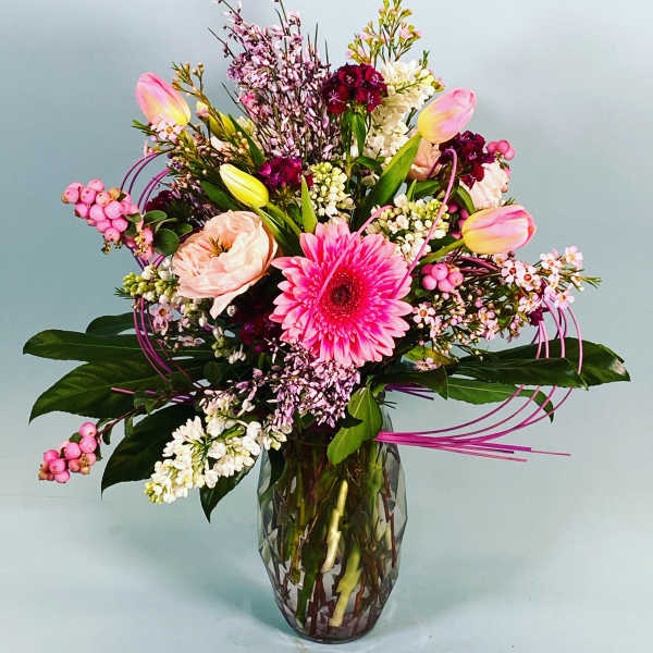 Mixed pink and white flowers in a glass vase