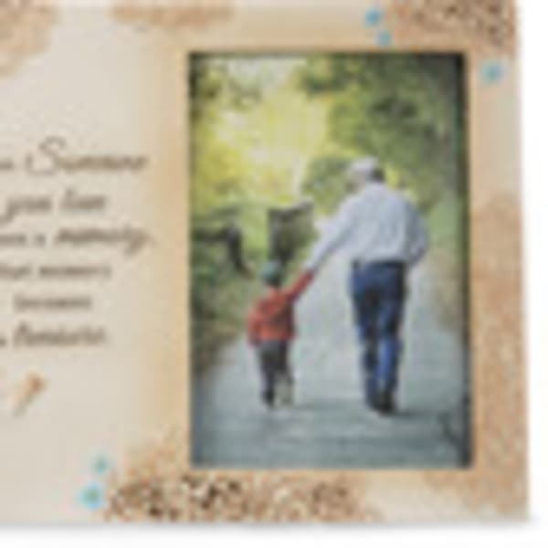 Blurred memorial card with a man and child walking on a path