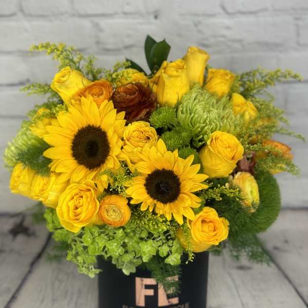 Yellow bouquet with sunflowers and roses in a black box