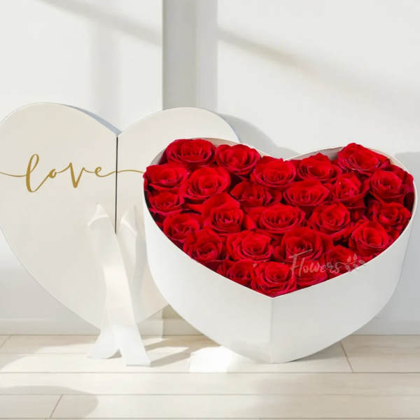 Heart-shaped box of red roses with a matching heart lid reading love