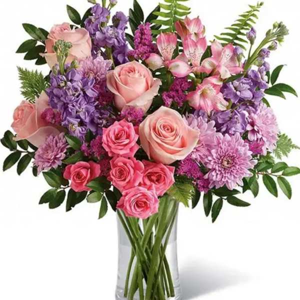 Pink and purple mixed bouquet in a clear glass vase