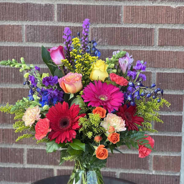 Colorful mixed bouquet in a clear glass vase