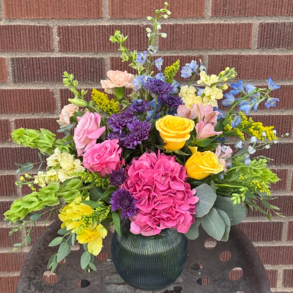 Colorful mixed bouquet in a ribbed glass vase