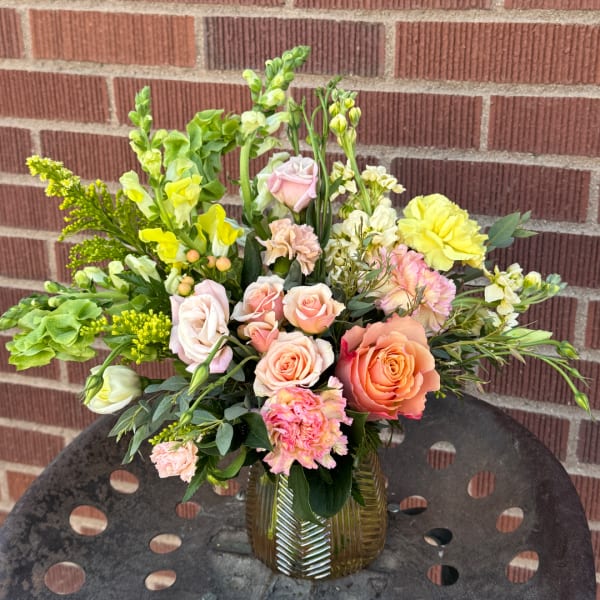 Mixed pastel bouquet in a ribbed glass vase