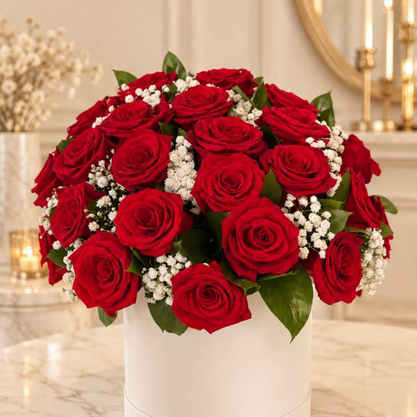 Red rose bouquet with white filler flowers in a white box