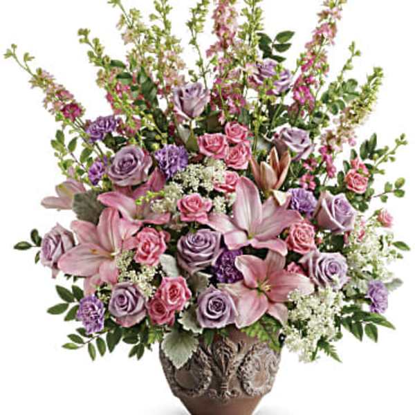 Tall pink and lavender flower arrangement in an ornate brown ceramic pot