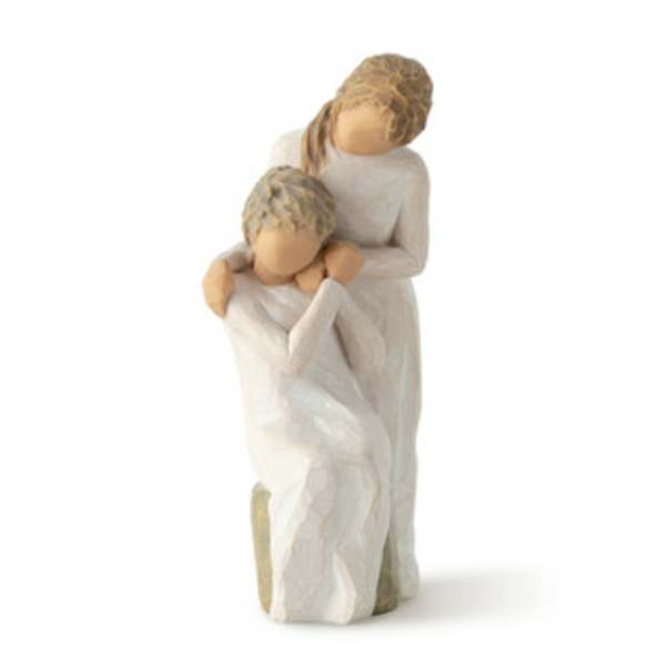 Two carved figures in white clothing embracing