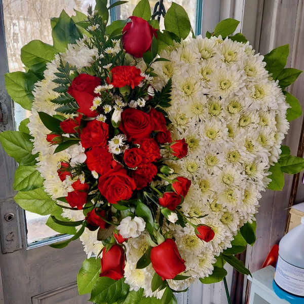 Heart-shaped floral arrangement with red roses and white chrysanthemums