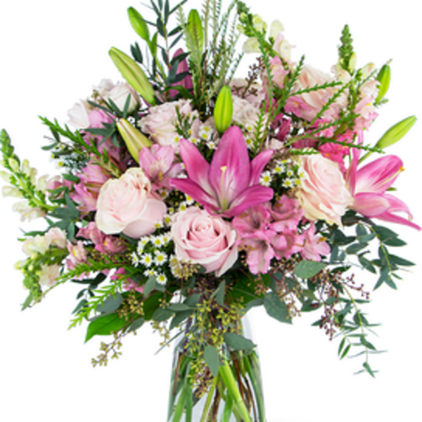 Tall pink and white bouquet with lilies and roses in a clear glass vase