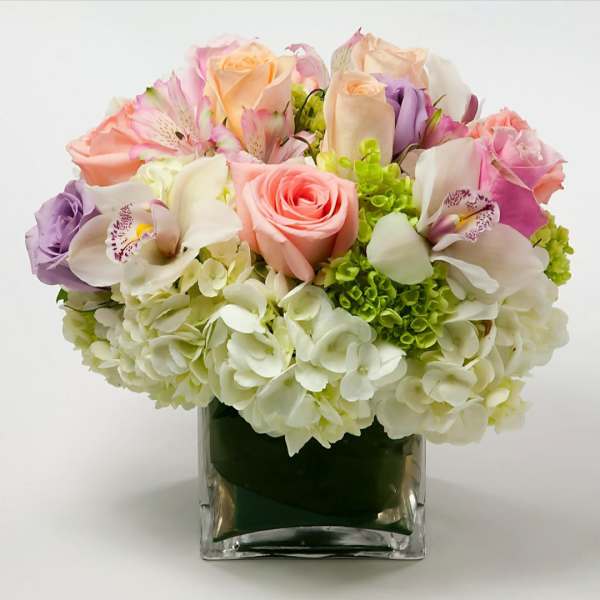 Mixed pastel bouquet in a square glass vase