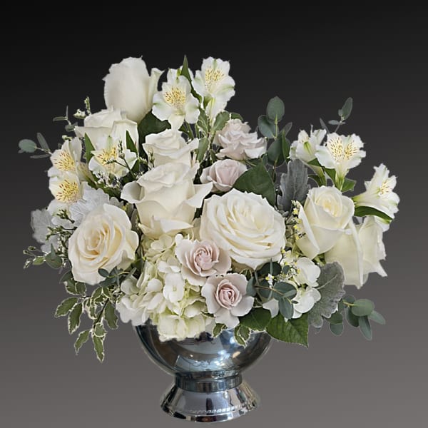 White rose arrangement in a silver vase
