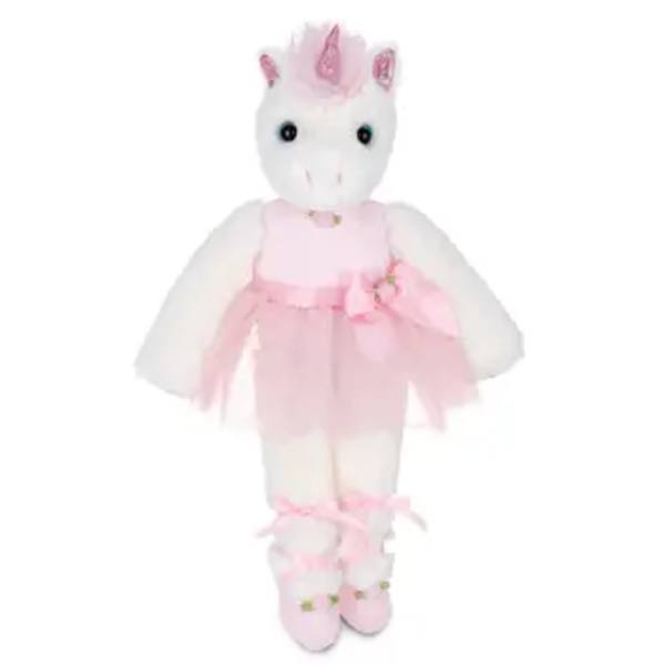 Stuffed white unicorn doll wearing a pink dress and matching shoes.